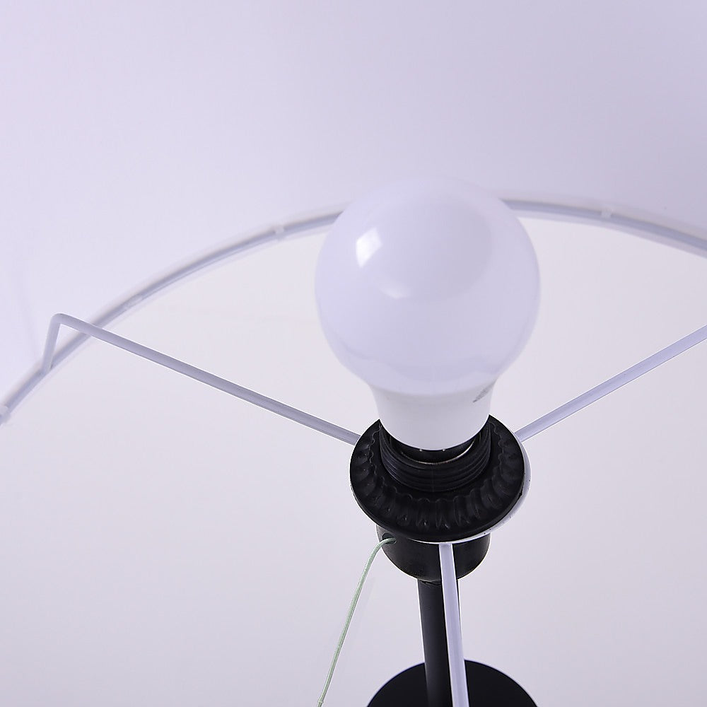 Mid century tripod floor lamp with ivory drum shade and black legs