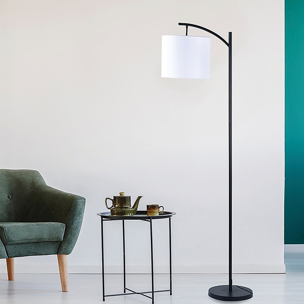 Arched floor lamp with ivory drum shade and black metal stand