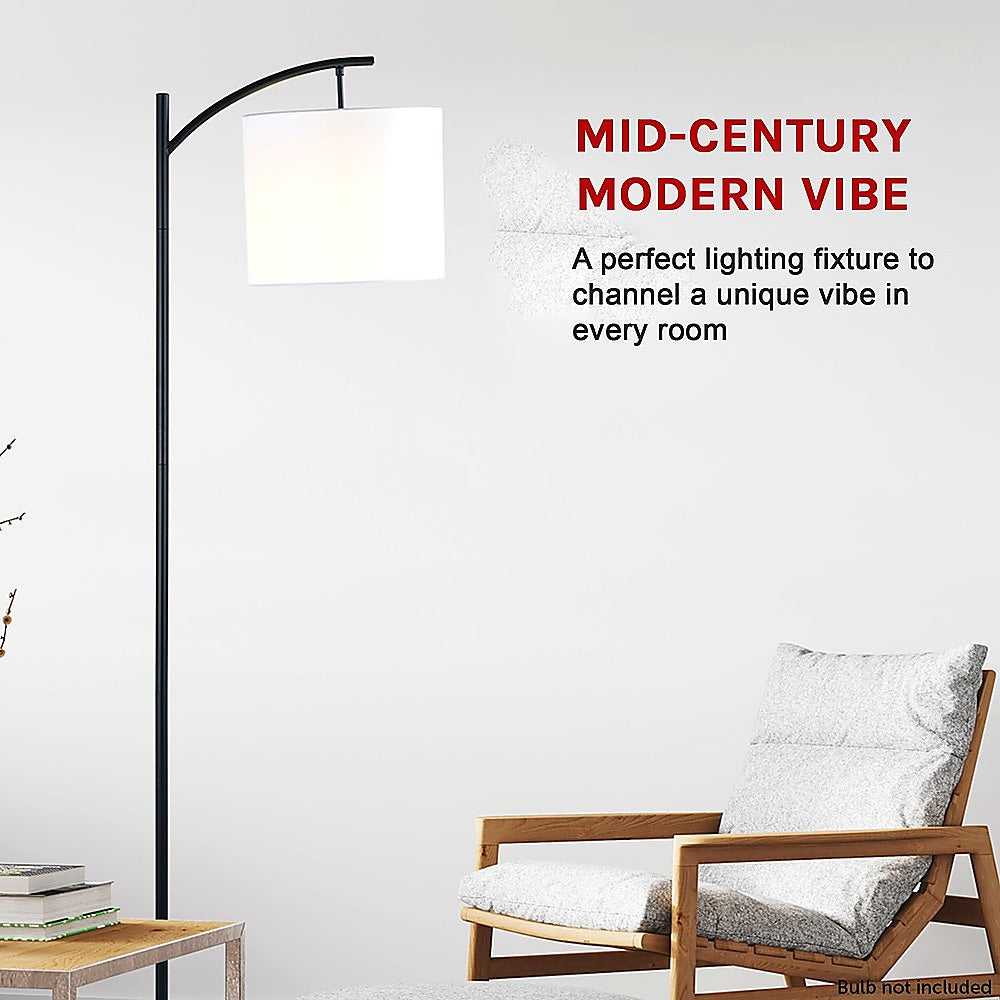 Arched floor lamp with ivory drum shade and black metal stand