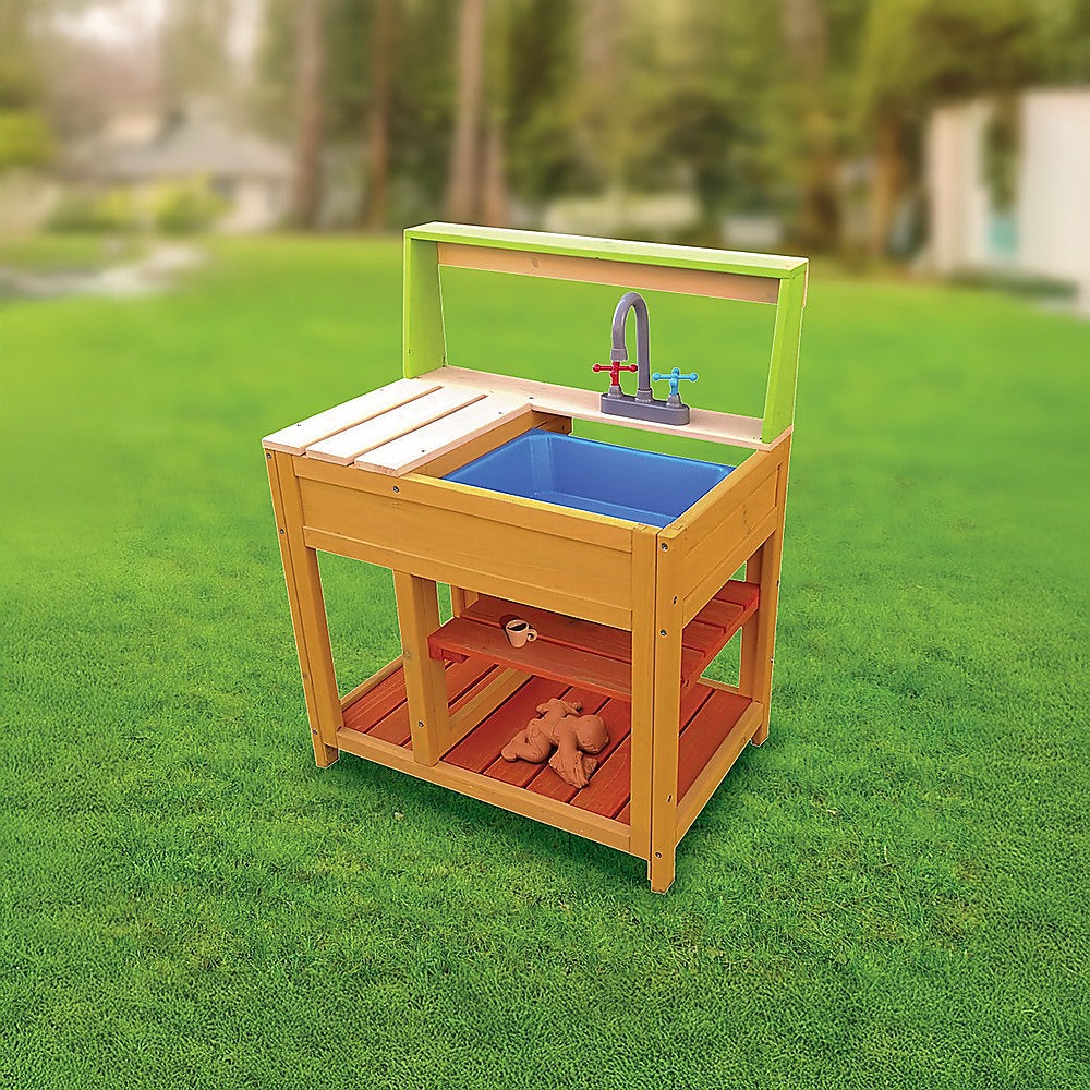 Child playing at wooden mud kitchen