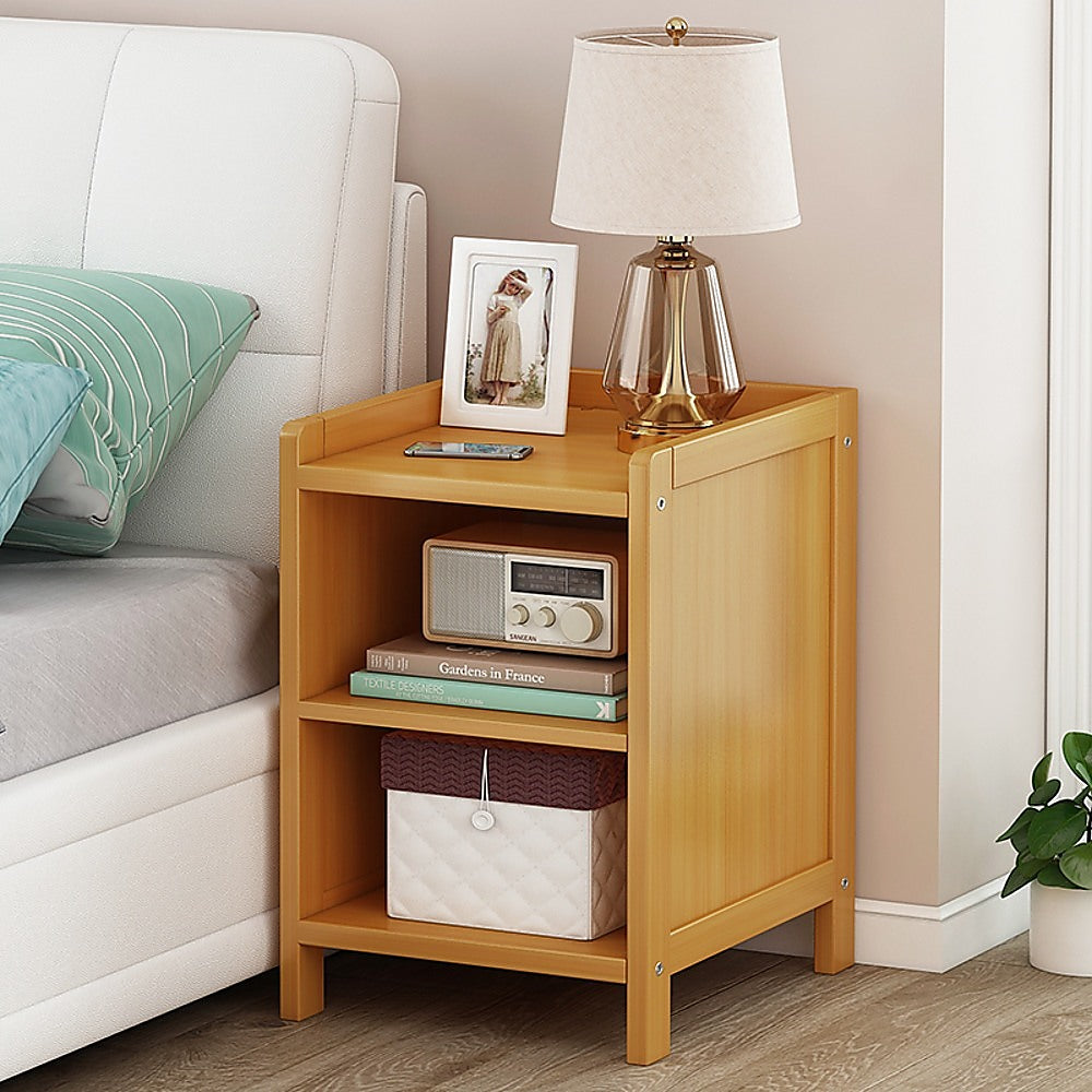 Ocean Shores natural compact bamboo bedside table with drawer and shelf in a bedroom