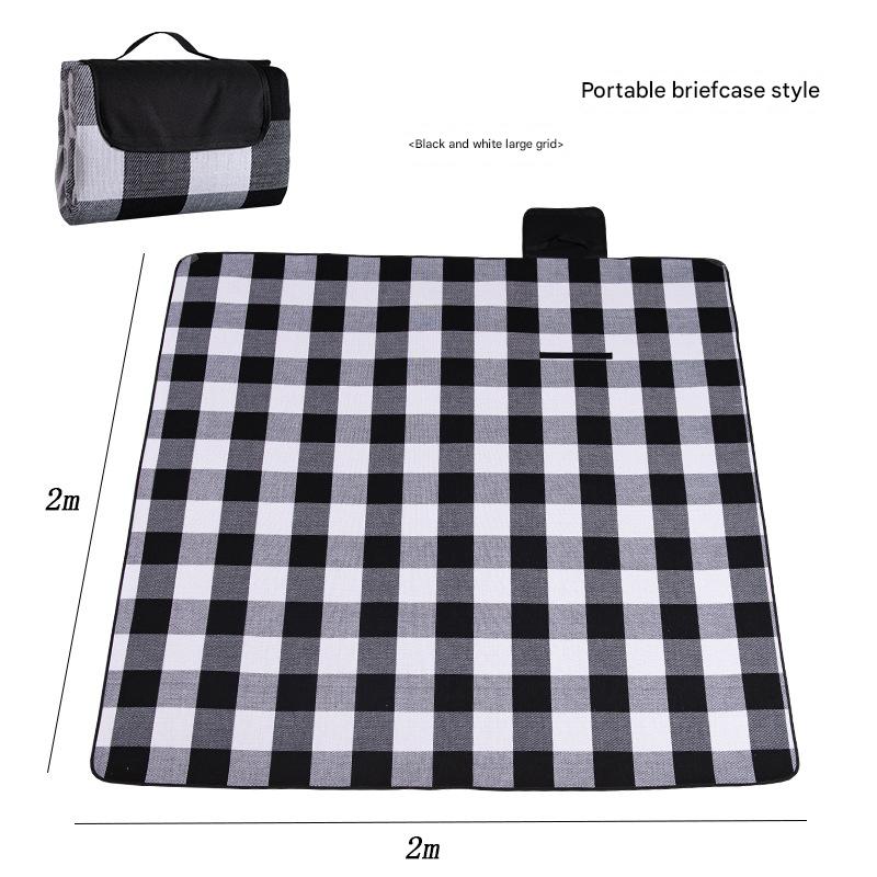 Hawkshead picnic blanket 200 x 200cm in black and white grid print laid on grass with soft fabric top and water resistant PEVA backing