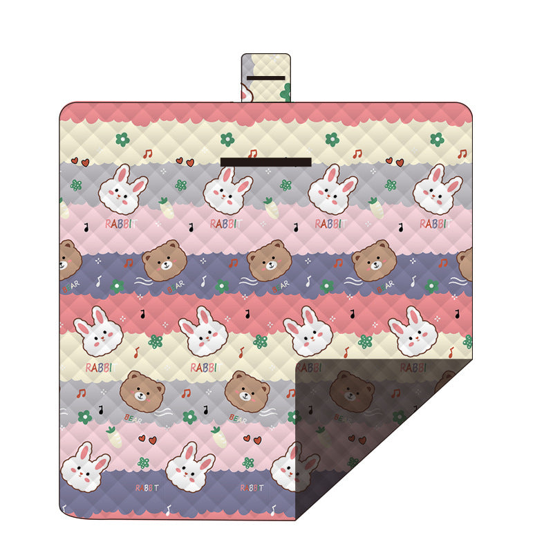 Hawkshead picnic blanket 200 x 200cm in musical bunny print laid on grass with soft fabric top and water resistant PEVA backing