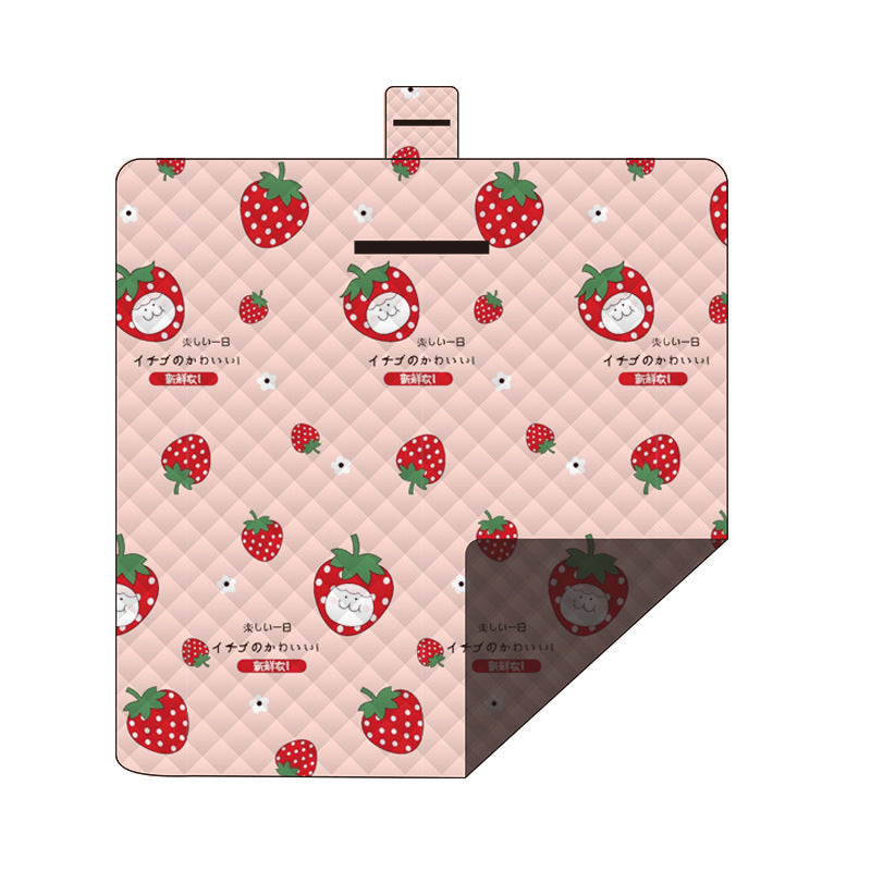 Hawkshead picnic blanket 200 x 200cm in strawberry print laid on grass with soft fabric top and water resistant PEVA backing