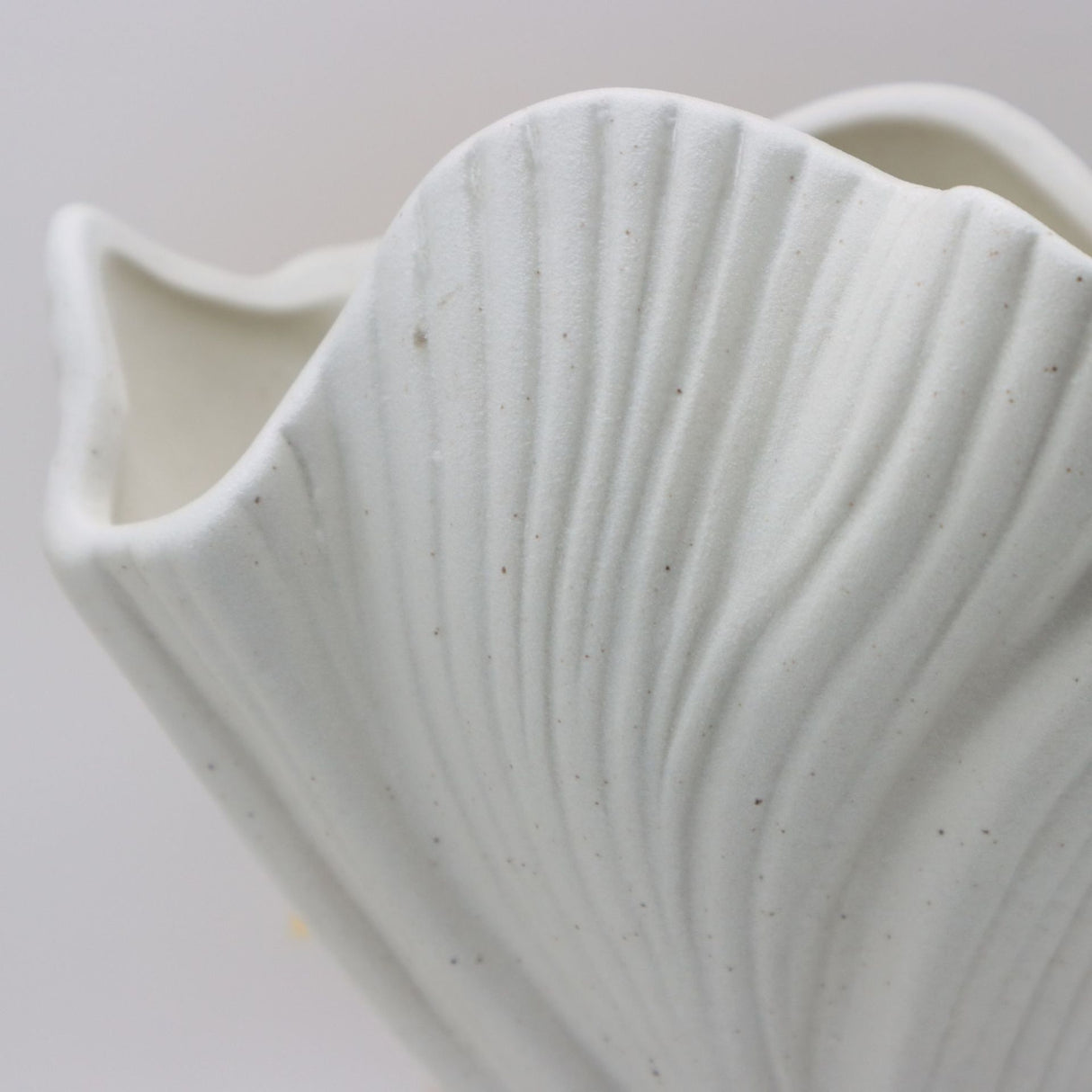 Beige sculptural ceramic vase with wide fluted opening