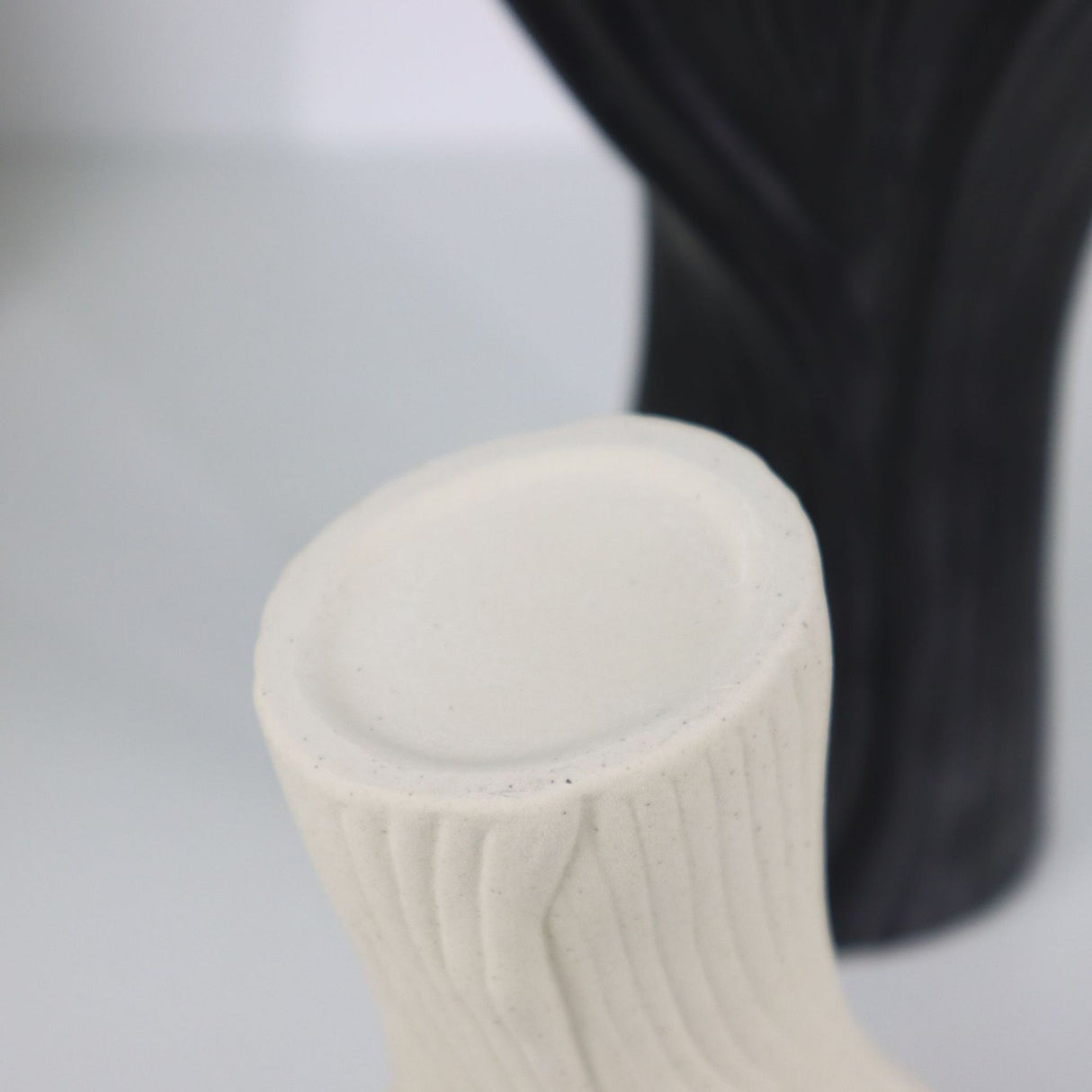 Beige sculptural ceramic vase with wide fluted opening