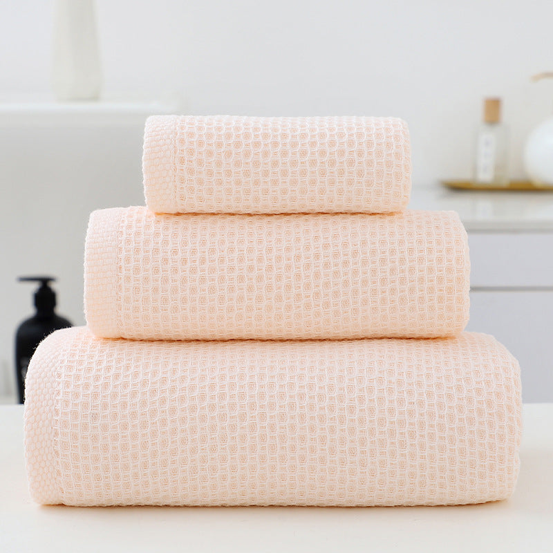 Three piece light pink waffle weave cotton towel set with bath towel, hand towel and face cloth