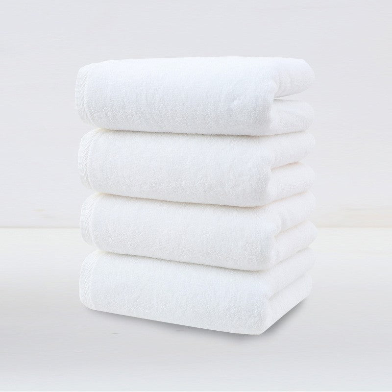 Four pack of white plush cotton hand towels folded and stacked