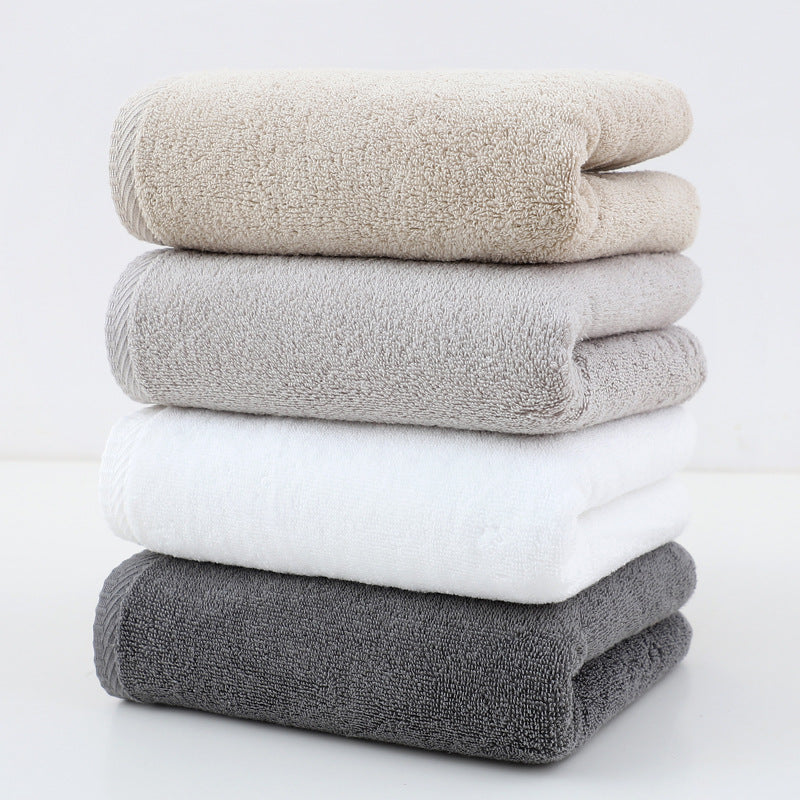 Set of 4 plush cotton hand towels in mixed colours, folded and stacked
