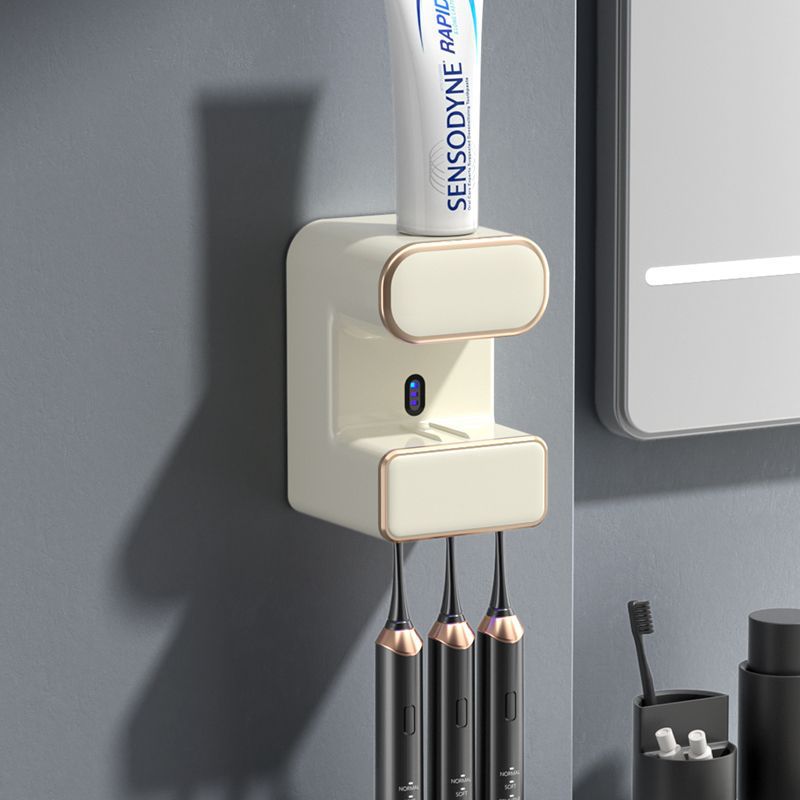 Beige wall mounted automatic toothpaste dispenser with UV steriliser and toothbrush holder