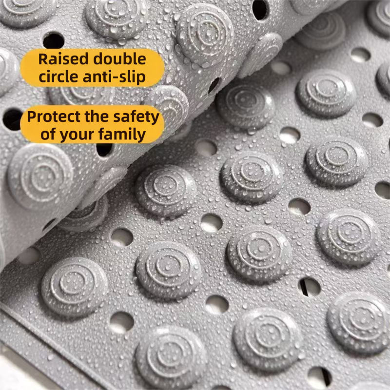 Close up of raised massage points and drainage holes on the khaki bath mat