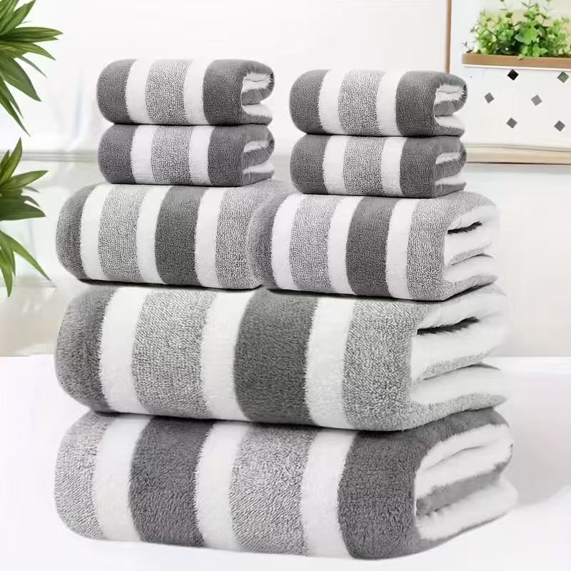Eight piece grey coral fleece towel set with bath sheets, towels and face cloths in a wide stripe texture