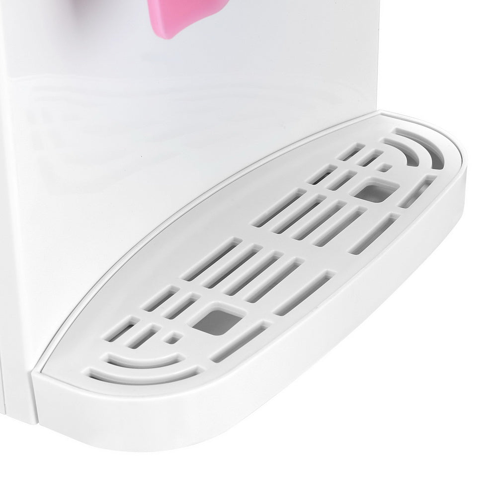 Close up of hot and cold water spouts on white bench top water cooler