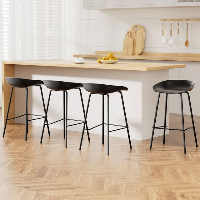 Carrum black metal bar stool with moulded seat in a minimalist kitchen