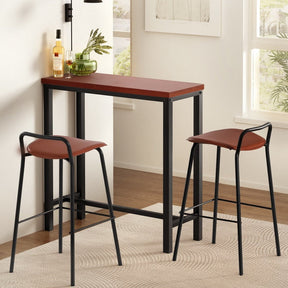 Moorooduc three piece bar set with industrial table and two brown faux leather stools in a kitchen