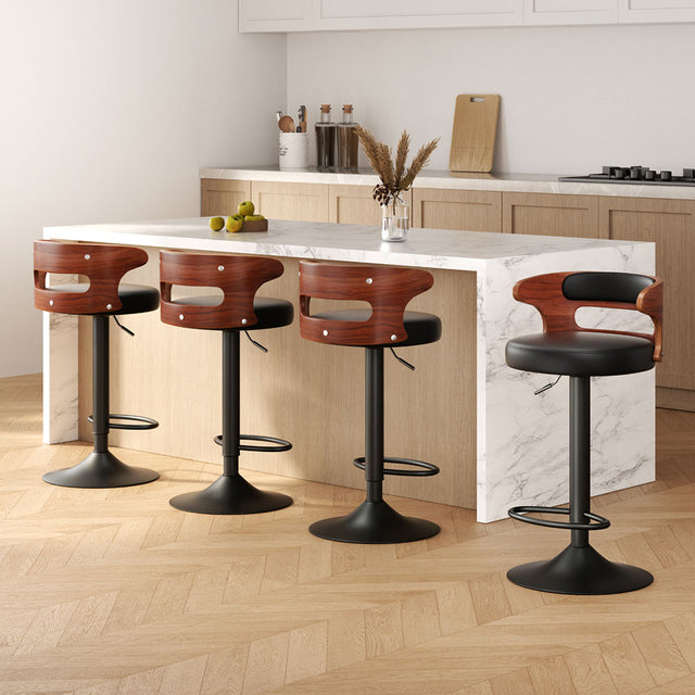 Merricks black PU leather gas lift bar stool 4pcs set with steel base at a kitchen island