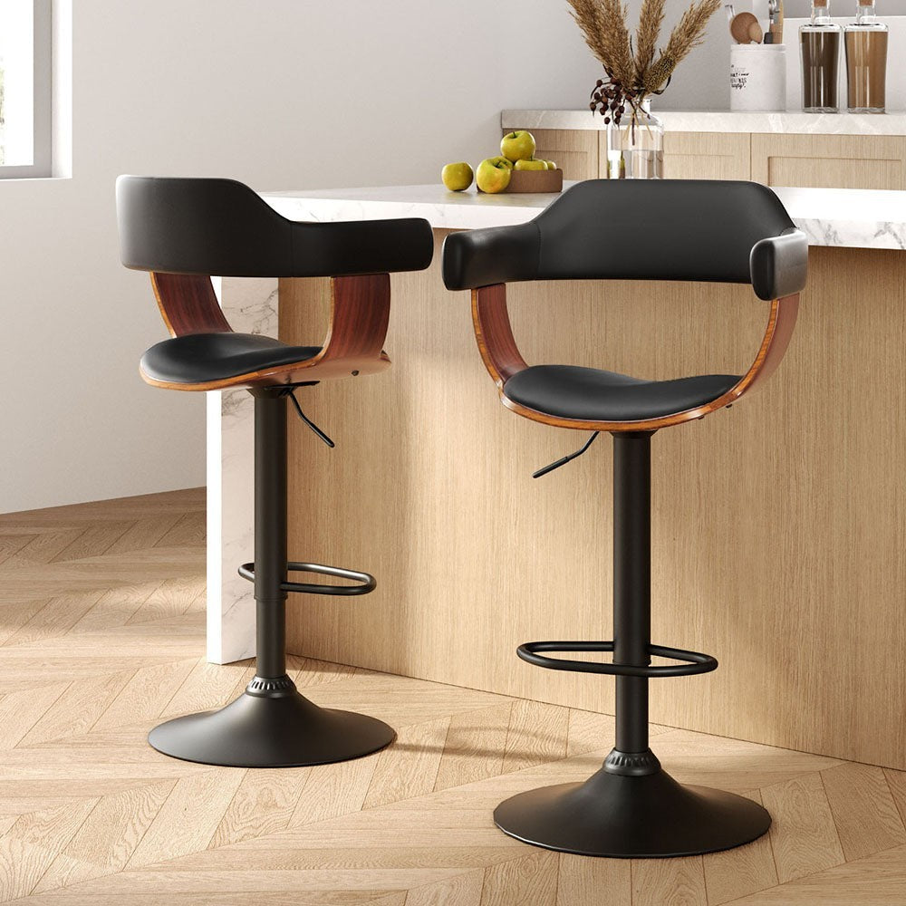 Dromana black faux leather swivel bar stool with armrests in a modern kitchen