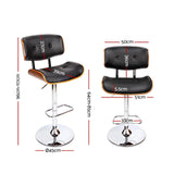 Cowes wooden gas lift bar stool black beside a kitchen island
