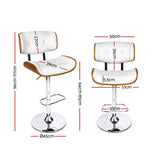Cowes wooden gas lift bar stool white beside a kitchen island