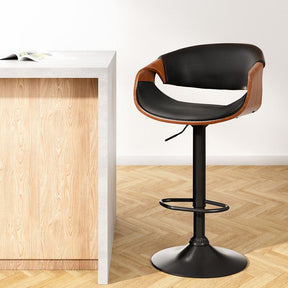 Tenby Point black gas lift swivel bar stool with curved backrest in a modern kitchen