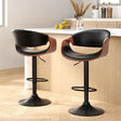 Tenby Point black gas lift swivel bar stool with curved backrest in a modern kitchen