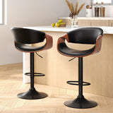 Tenby Point black gas lift swivel bar stool with curved backrest in a modern kitchen