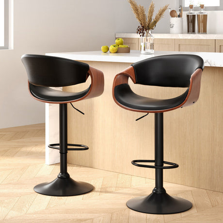 Tenby Point black gas lift swivel bar stool with curved backrest in a modern kitchen