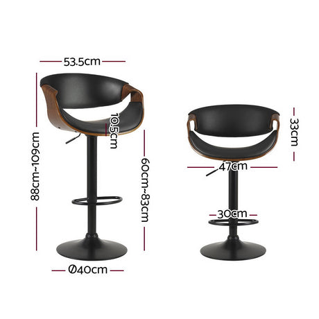Tenby Point black gas lift swivel bar stool with curved backrest in a modern kitchen