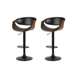 Tenby Point black gas lift swivel bar stool with curved backrest in a modern kitchen