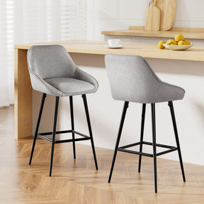 Beaumaris grey upholstered bar stool with winged backrest at a kitchen counter
