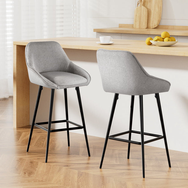 Beaumaris grey upholstered bar stool with winged backrest at a kitchen counter