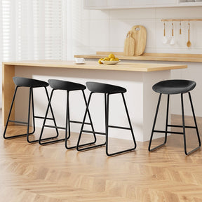 Sullivan Bay black faux leather padded metal bar stool at a kitchen counter