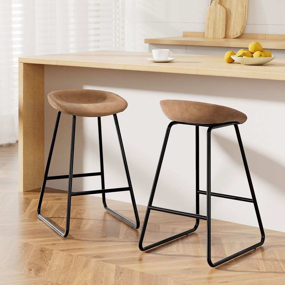 Sullivan Bay brown faux leather padded metal bar stool at a kitchen counter