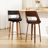 Highett black swivel faux leather bar stool with walnut legs in a modern kitchen