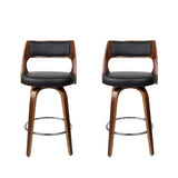 Highett black swivel faux leather bar stool with walnut legs in a modern kitchen