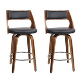 Highett black swivel faux leather bar stool with walnut legs in a modern kitchen