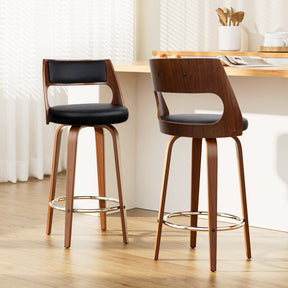 Highett black swivel faux leather bar stool with walnut legs in a modern kitchen