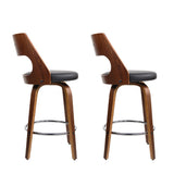 Highett black swivel faux leather bar stool with walnut legs in a modern kitchen