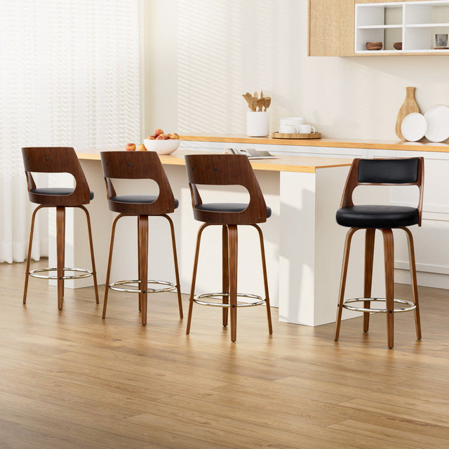 Highett black swivel faux leather bar stool with walnut legs in a modern kitchen