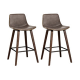 Devilbend walnut wooden bar stool with faux leather seat in a warm kitchen