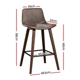 Devilbend walnut wooden bar stool with faux leather seat in a warm kitchen