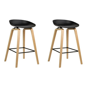 Langwarrin black solid timber bar stools pair at a kitchen counter
