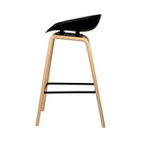London Bridge black wooden bar stool with moulded seat at a kitchen counter