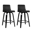Balcombe black swivel wooden bar stool with padded seat in a modern kitchen