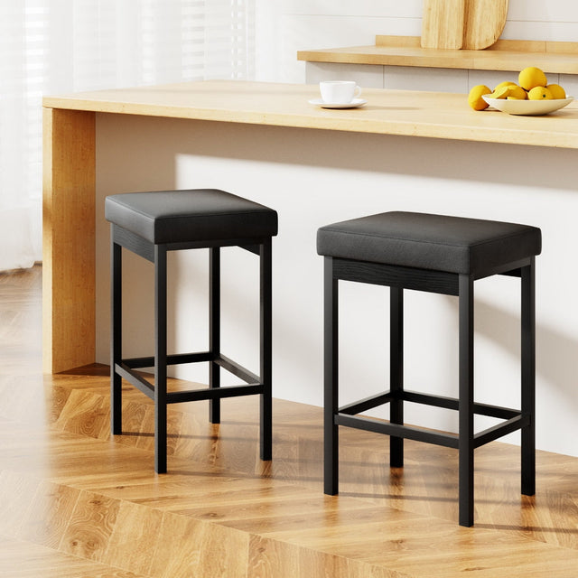 Crib Point black metal bar stool with faux leather memory foam seat in a kitchen