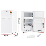 85 L white bar fridge shown at an angle with door closed