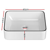 White ceramic above counter basin with black rim line, front view