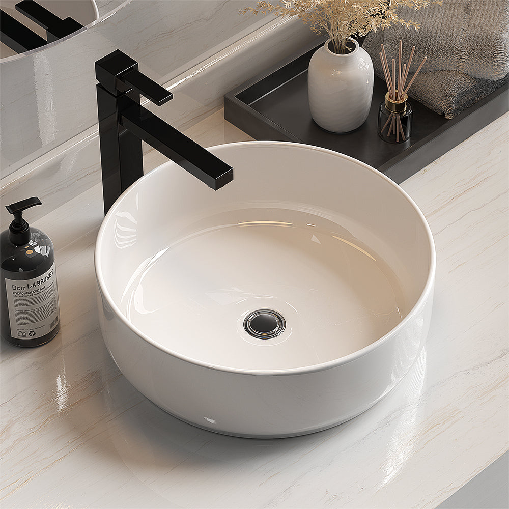 Above counter white round ceramic wash basin, angled view