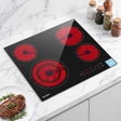 Black ceramic cooktop with four burners, top down view