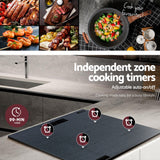 Underside of the cooktop showing heating elements and cooling fan